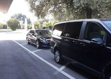 Private driver assisting with luggage during Rome to Civitavecchia transfer